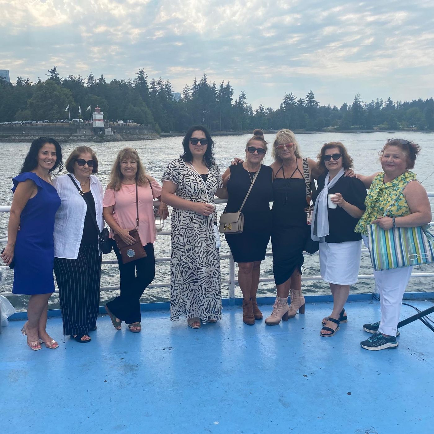 TCA Vancouver members on the deck of the brunch cruise with Stanley Park behind them